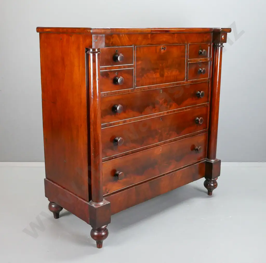 Victorian mahogany 7-drawer chest with figured mahogany drawer fronts, turned wooden knobs, columns to sides and bun Image 1++