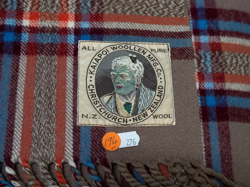 woollen travel rug with Kaiapoi Woollen Christchurch Maori chief label - some fading and spots of staining Image 1++