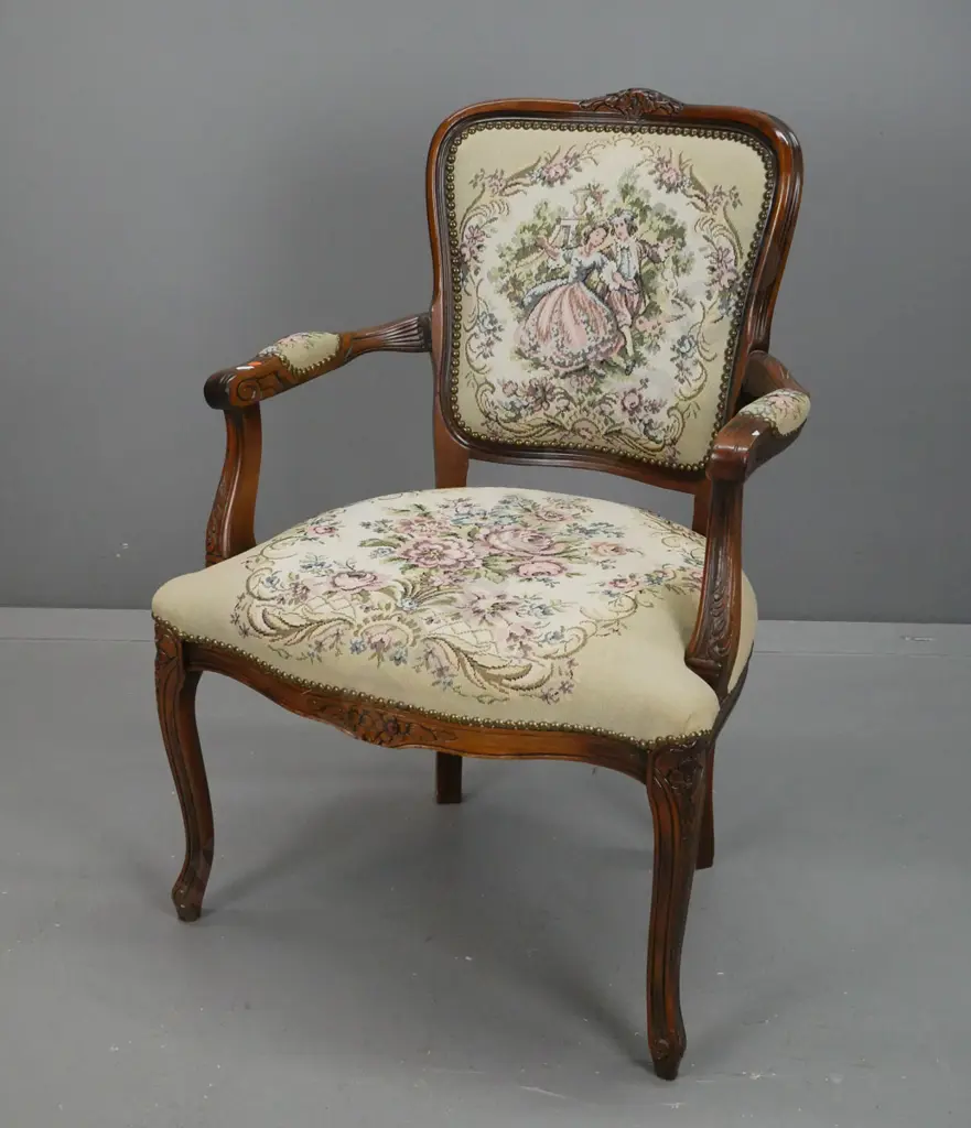 beech French style open armed chair with floral carving to back and arms, brass studded tapestry upholstery. Minor wear Image 1++