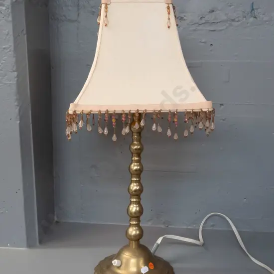 brass table lamp with scalloped edge circular base, candlestick style stem, square panelled shade with beaded trim -