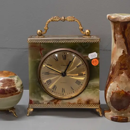 3 pieces of agate or polished stone with brass finish fittings - mantel clock, orb on tripod base, and a vase. Steiger