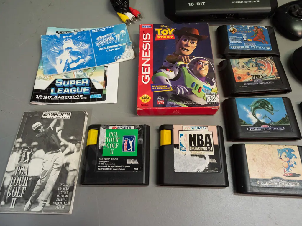 Sega Mega-Drive II 16 Bit video game console with 5 controllers, power supply, 14 game cartridges and a few booklets Image 1++