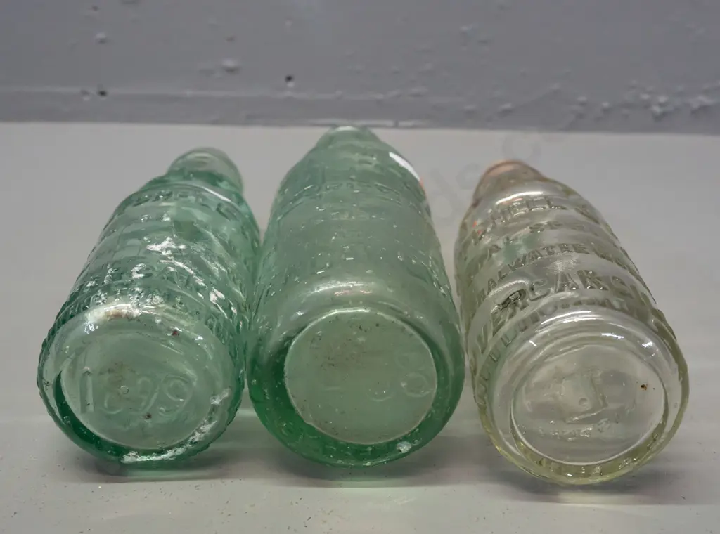 3 clear glass codd / marble bottles - 2 are Mitchell & Co Invercargill, one marked MGB Co. on back, no date, other 1899 Image 1++