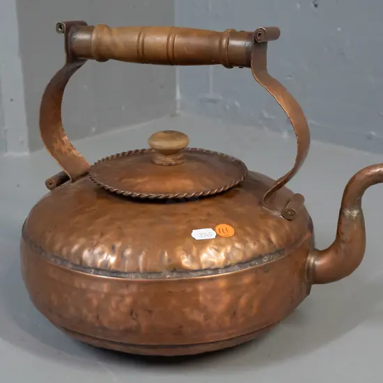 vintage hand-beaten copper kettle with turned wooden handle and knob, rope-twist edging on lid - some discolouration,