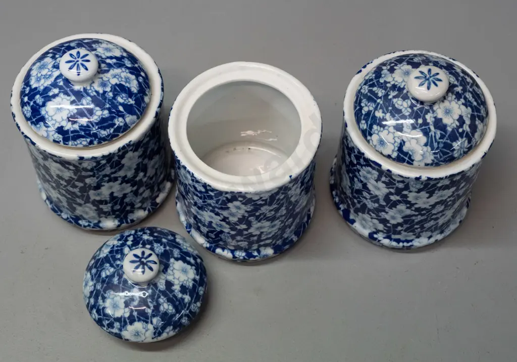 7 pieces of Chinese blue & white AOF prunus / calico style porcelain - 3 lidded canisters, 2 egg cups, pair of candle- Image 1++