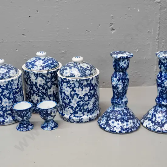 7 pieces of Chinese blue & white AOF prunus / calico style porcelain - 3 lidded canisters, 2 egg cups, pair of candle-