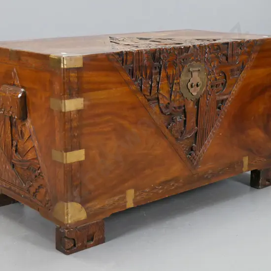 vintage Chinese carved camphorwood chest with brass strapping and corners w/ carved block side handles and feet, shaped
