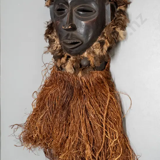 African carved wood mask with fibre and feather decoration & metal bell. Chokwe, Democratic Republic of Congo H-820