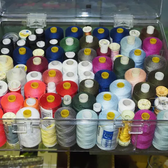 plastic container of sewing threads
