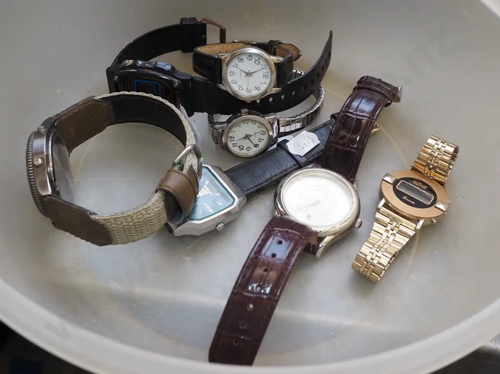 plastic bowl of wristwatches Image 1++