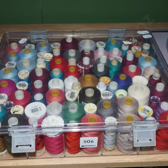 container of sewing threads