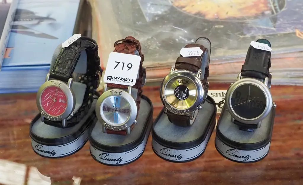4xBeatles themed  wristwatches on stands Image 1++