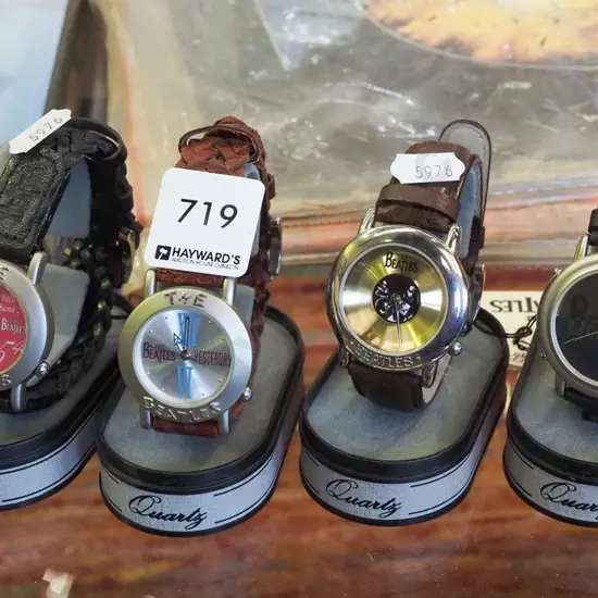 4xBeatles themed  wristwatches on stands