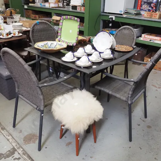 alloy and black glass top outdoor table with 4 matching woven plastic armchairs H740 W930 D1020