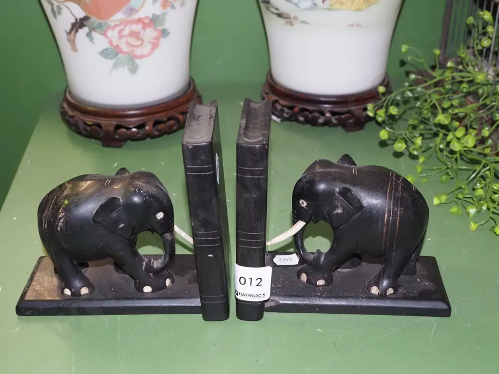 2x ebony elephant bookends - some trunks missing Image 1++