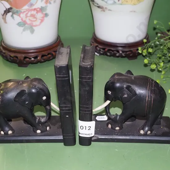2x ebony elephant bookends - some trunks missing