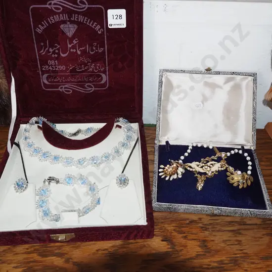 cased necklace and bracelet set, one other set
