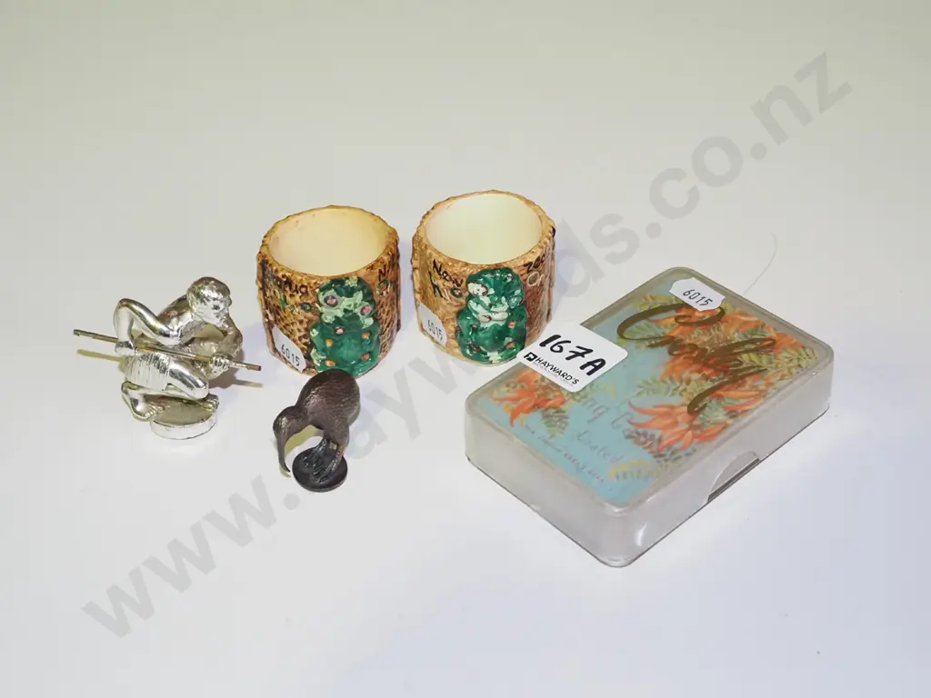 NZ souvenir items; 2 ceramic tiki egg cups (chips to paint), 2x cast metal figures, deck of kaka beak cards  Image 1++