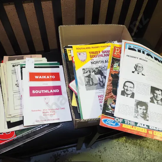 box of various rugby programmes