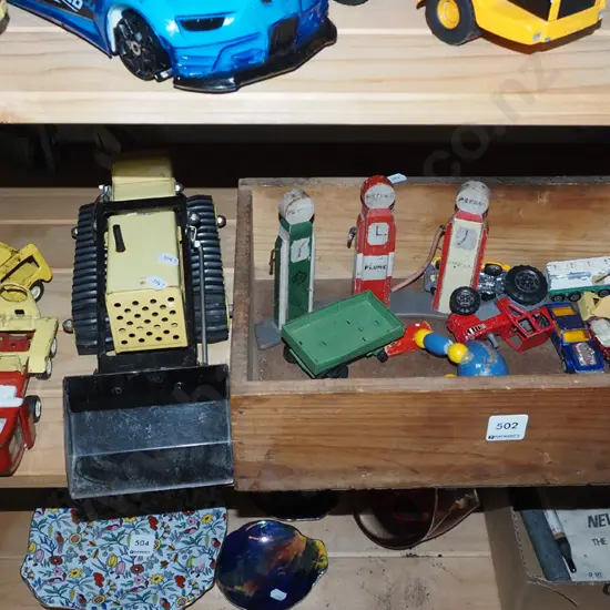 wooden box, toy vehicles, petrol pumps etc