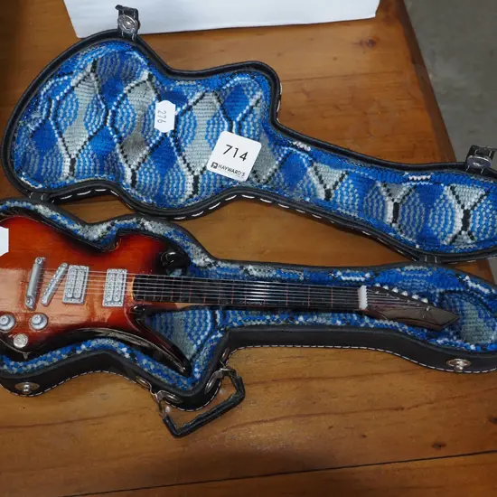 miniature electric guitar in case