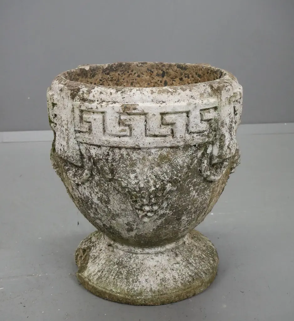 cast concrete garden planter with Greek key pattern and grape decoration on circular fluted base. Image 1++
