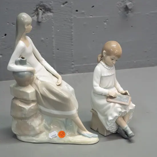 2 Nao figurines - seated woman with urn H-250 W-170 and seated girl with slate