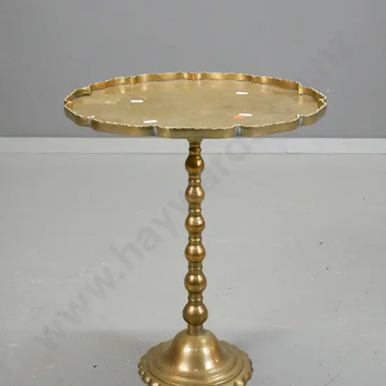 brass scallop-edged circular topped wine table with bobbin shaped column to circular shaped base, engraved foliate &