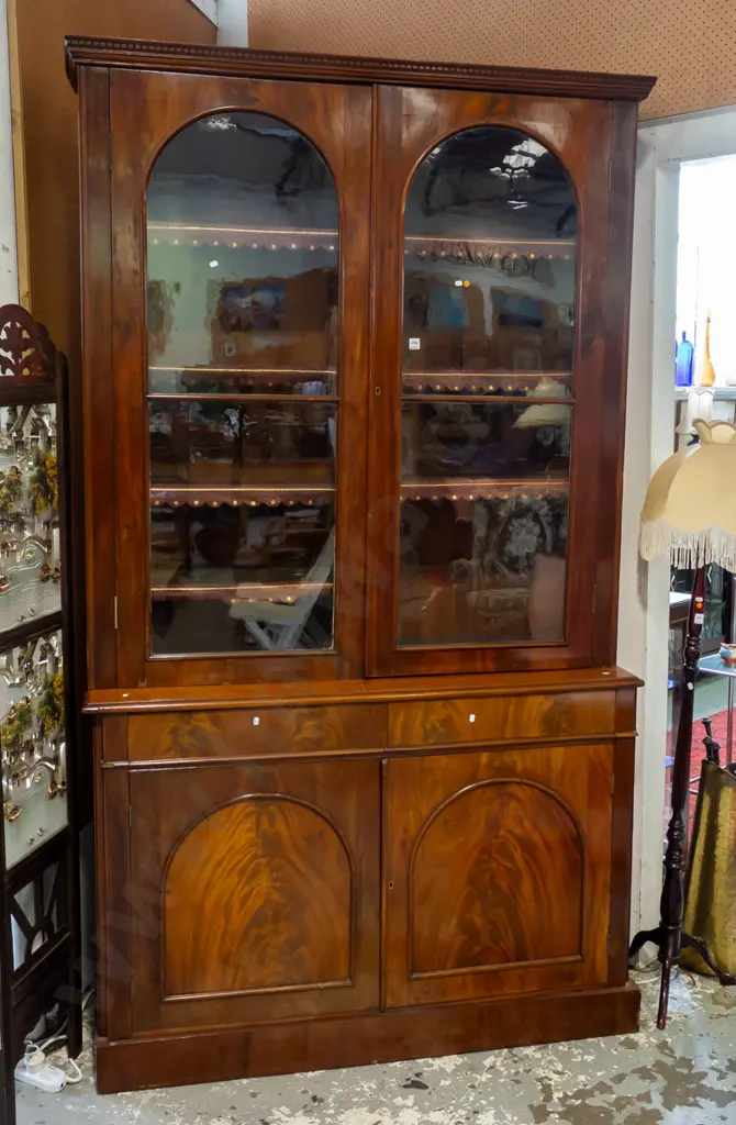 Victorian flame mahogany bookcase chiffonier, dentil moulding to cornice, 2 arched glazed cupboard doors, 8 adjustable Image 1++