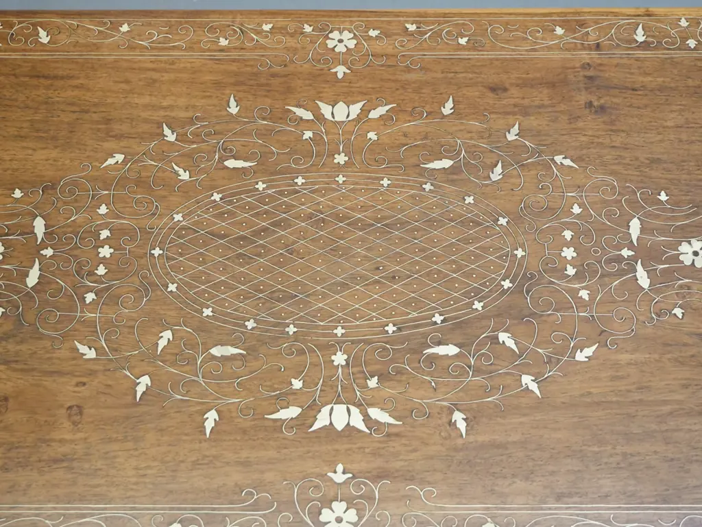 asian teak coffee table with brass scrolling inlays. Repairs to legs, dark filler repair to one leg, missing some inlay. Image 1++