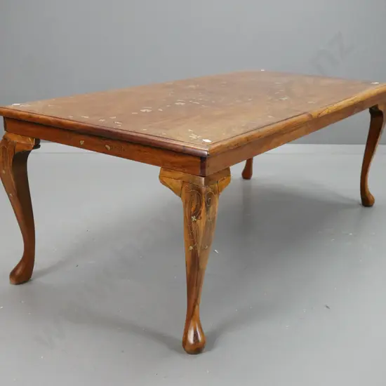 asian teak coffee table with brass scrolling inlays. Repairs to legs, dark filler repair to one leg, missing some inlay.
