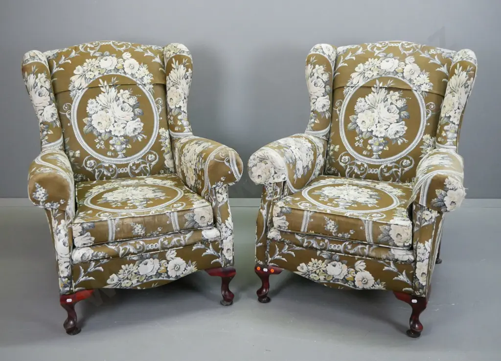 pair of mid-century floral upholstered rolled arm wingback chairs on short cab legs. Wear to top of one wing, some Image 1++