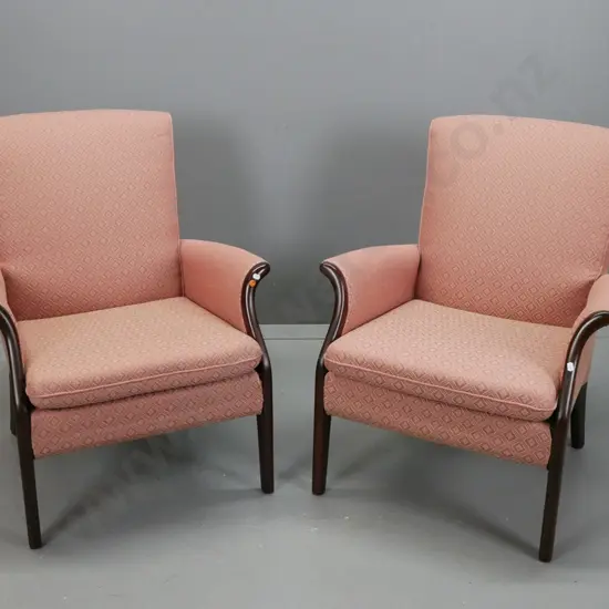 pair of Parker Knoll fireside chairs, exposed mahogany arms and legs, upholstered in salmon diamond print fabric, some