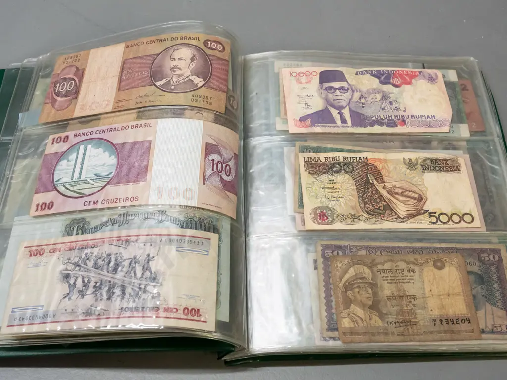 album full of assorted banknotes - a few NZ dollars, otherwise international Image 1++