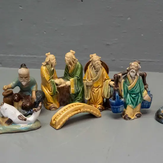 6 small Chinese earthenware "mud men" figures and a small bridge piece - one fisherman missing a pole. Largest H80 W60