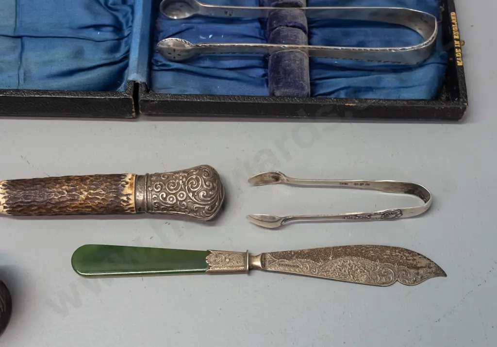 assorted silver napkin rings, sugar tongs, fork with antler handle and butter knife with greenstone handle - most marked Image 1++