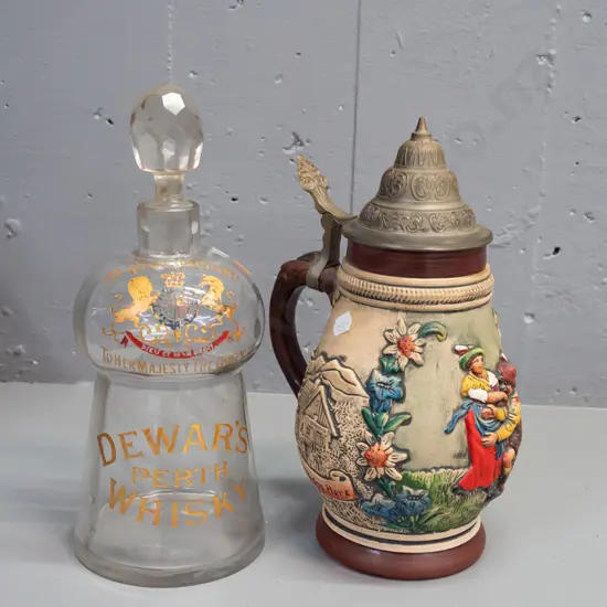 vintage Dewar's whisky glass stoppered decanter and a pewter-lidded German beer tankard. Decanter has rubbing to