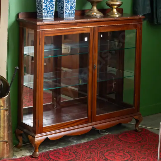 mahogany 1980's mirror backed display case with glazed sides, molded top above 2 glazed doors