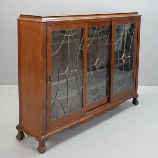 art nouveau style mahogany display or book case with 3 sliding leadlight doors, cup handles, 3 adjustable shelves,