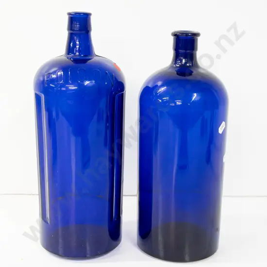 2 large Bristol blue glass bottles, one marked Poison on shoulder H-340, other with faint scratched markings,