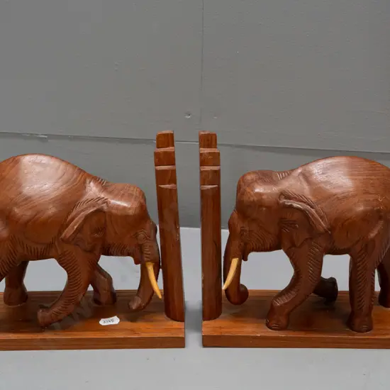 pair of carved teak elephant book-ends with stepped ends, timber tusks H-180 L-230 W-85