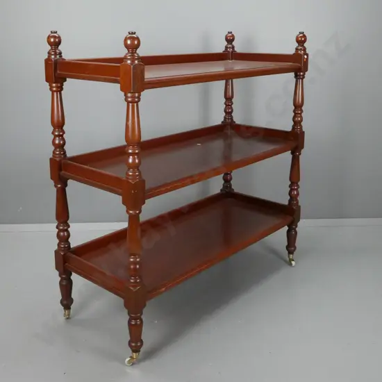 Victorian 3-tiered cedar dumbwaiter w/ turned supports on white china casters. Some scratching to surfaces. H-1250