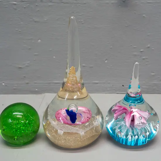 3 glass paperweights - 2 teardrop shaped with floral designs, taller is H-160, and a small Hokitika green bubble globe