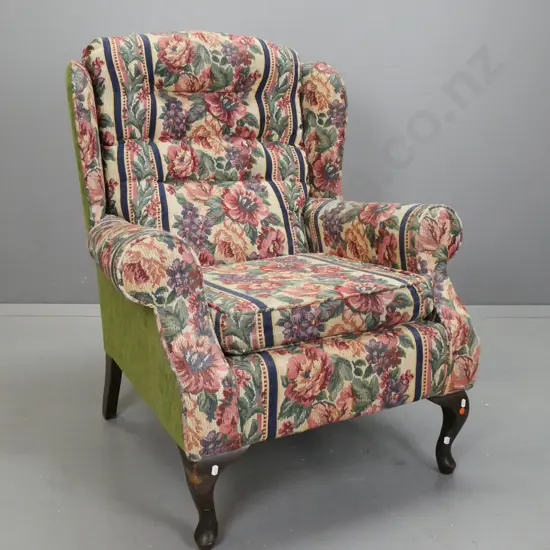 upholstered wing back rolled arm chair with deep button back & lift out upholstered seat on short cabriole legs. Floral