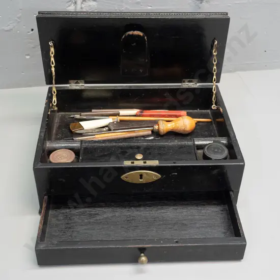 traveling writing box, ebonized timber, brass swan neck handles, lift up lid exposing 2 ink wells,
