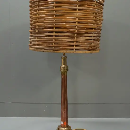 table lamp with heavy base made from industrial brass and copper parts and timber, with woven cane shade. Denting to
