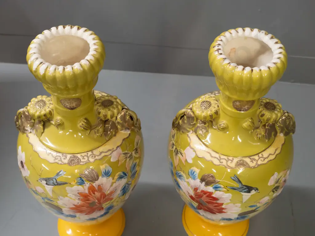 pair of Satsuma style hand decorated floral & bird motif vases with fluted bud-shaped top, applied floral handles. Both Image 1++