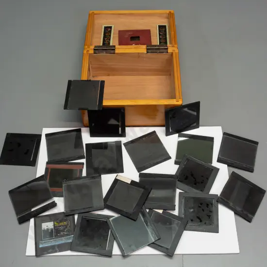 wooden box with assorted glass lantern slides, mostly (hand painted?) amateur houses and scenics, including a 16mm film