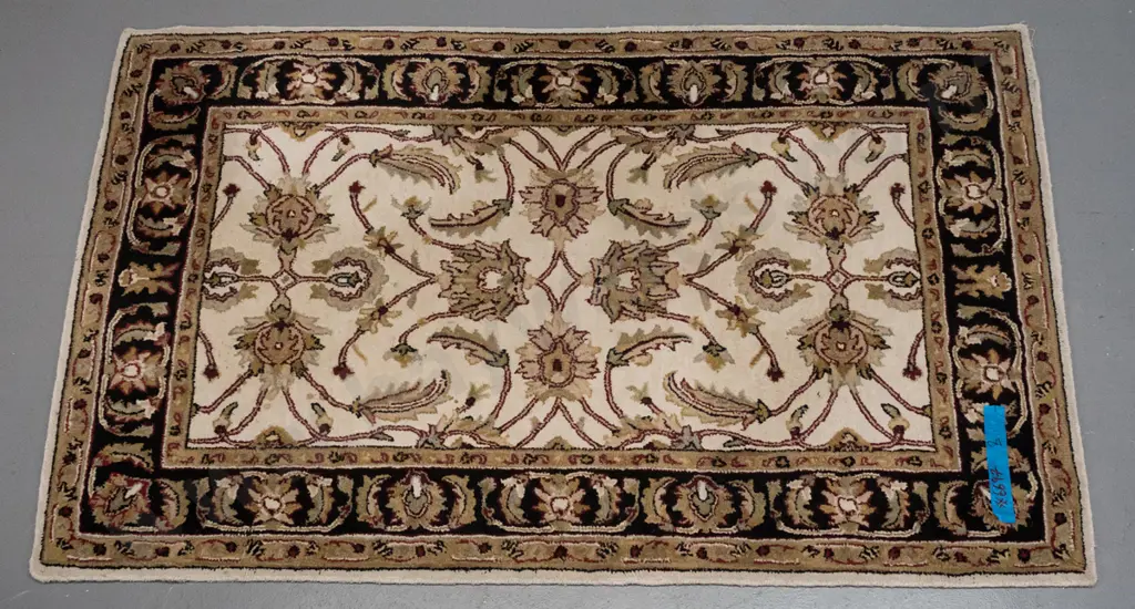 woolen Indian floor rug (Kohinoor) swirling foliate & floral decoration, ivory, red & black colours H1820 W1210 Image 1++