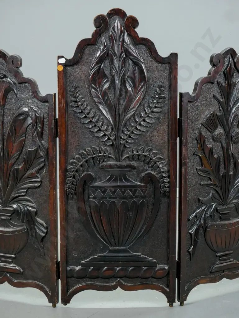 vintage dark-stained kauri carved 3-fold fire screen. Carved panels depicting urns holding Scotch thistle, lily, & fern Image 1++